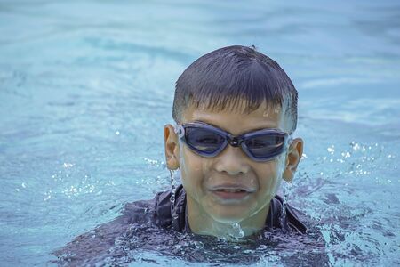 Asian boy learned to swim in the pool.の写真素材