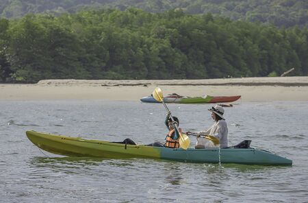 Mother and son kayaking in the sea at Koh Kood, Trat in Thailand.の写真素材