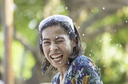 Asian woman play water in Songkran festival or Thai new year in Thailand.の写真素材