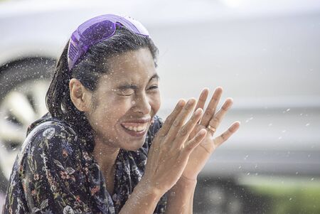 Asian woman play water in Songkran festival or Thai new year in Thailand.の写真素材