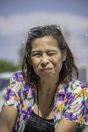Asian woman play water in Songkran festival or Thai new year in Thailand.の写真素材