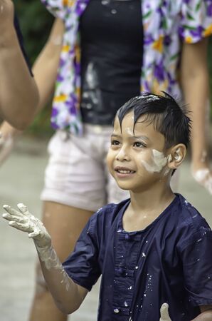 Asian boy play water and flour in Songkran festival or Thai new year in Thailand.の写真素材
