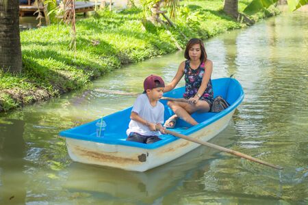 Mother and son boating on the park.の写真素材