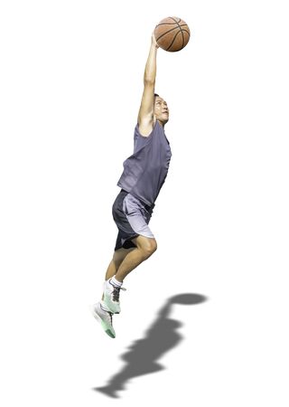 Isolated Basketball in hand man jumping on a white background with clipping path...の写真素材