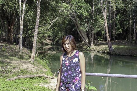 woman and water in the stream is green and bright green tree at Kapo Waterfall Fores Park , Chumphon in Thailand.の写真素材