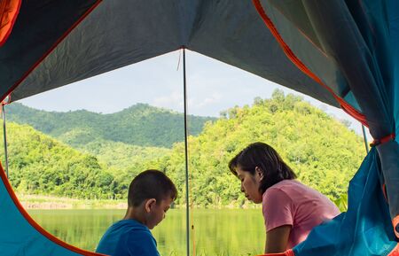 Portrait of a boy and woman ,The background of mountains and water.の写真素材