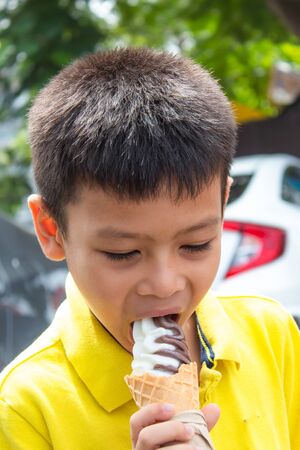 Asian boys are eating ice cream.の写真素材