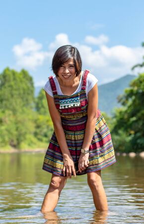 Asian women wear native Thailand Standing in a stream.の写真素材