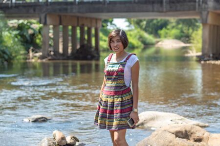 Asian women wear native Thailand Standing in a stream.の写真素材