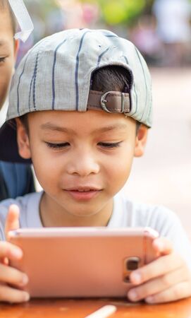 Portrait of the boy are playing a phone.の写真素材