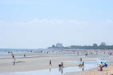 Many tourists walk on the beach and garbage on the coast at low tide Background sea and large buildings at Bangsaen Beach, Chonburi in Thailand. June 21 , 2020のeditorial素材