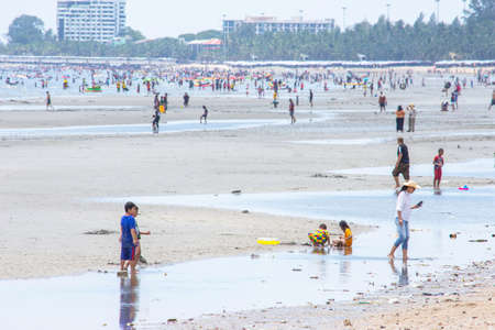 Many tourists walk on the beach and garbage on the coast at low tide Background sea and large buildings at Bangsaen Beach, Chonburi in Thailand. June 21 , 2020のeditorial素材