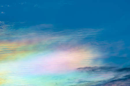 The beauty of the rainbow clouds Above the black clouds in the evening.の写真素材