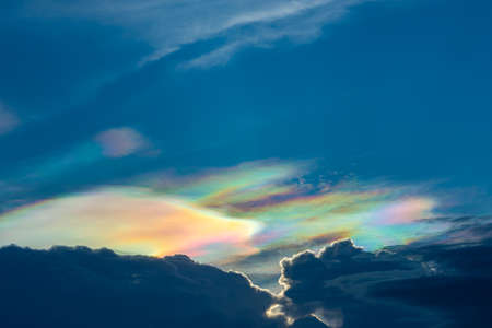 The beauty of the rainbow clouds Above the black clouds in the evening.の写真素材