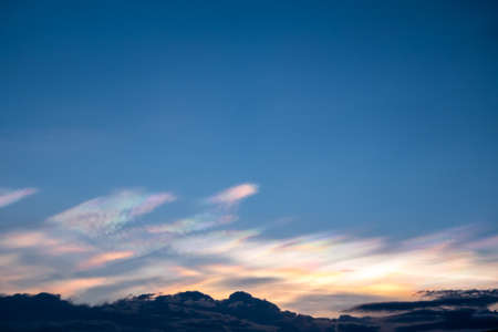 The beauty of the rainbow clouds Above the black clouds in the evening.の写真素材