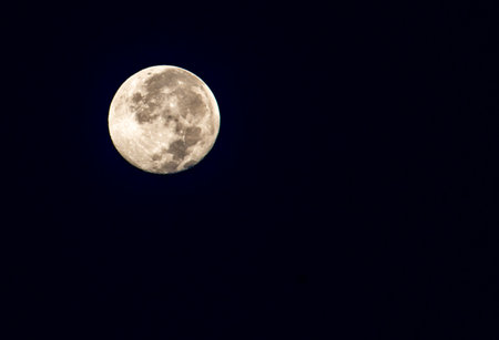 The full moon in the sky at night is black.の写真素材
