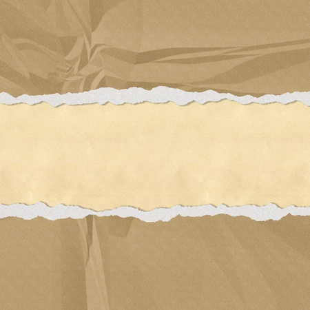 Hole in the brown paper with torn sides paper textureの写真素材