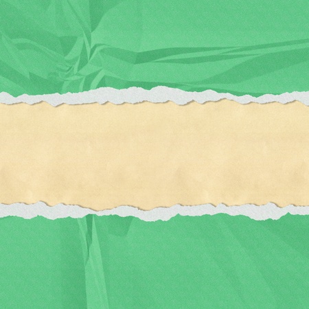 Hole in the green paper with torn sides paper textureの写真素材