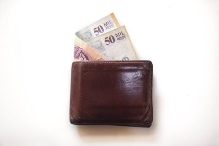 Wallet with 50000 Colombian pesos bills sticking out