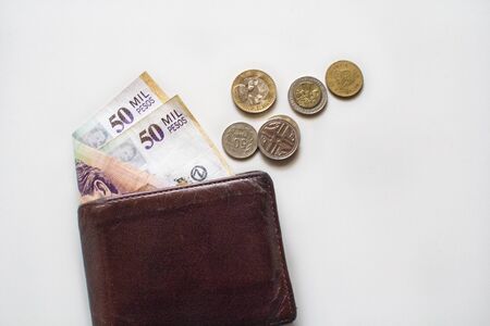 50000 COP Colombian Pesos in a wallet and Colombian change / coins on side isolatedの写真素材