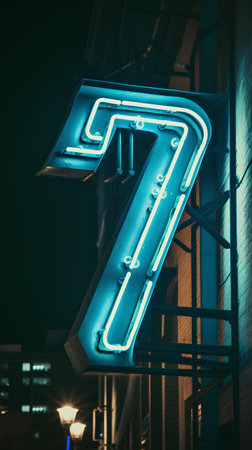Neon sign in the shape of a number 7 on a dark backgroundの素材