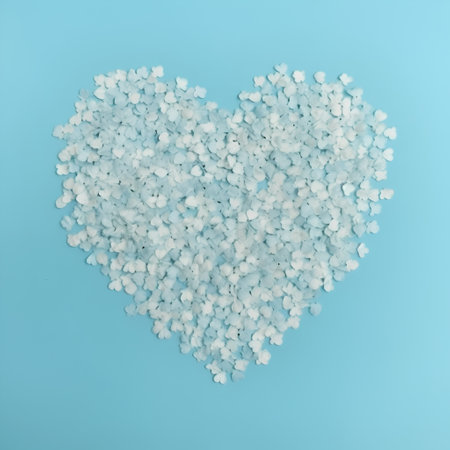 Heart of sea salt on blue background. Flat lay, top viewの素材
