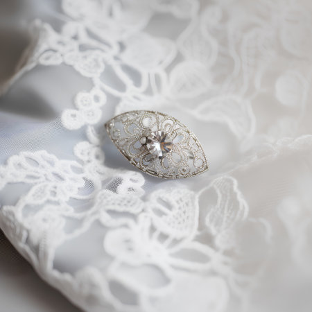 Silver wedding ring on a white lace background, close-up.の素材