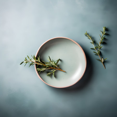 Plate with sprigs of rosemary on a blue backgroundの素材