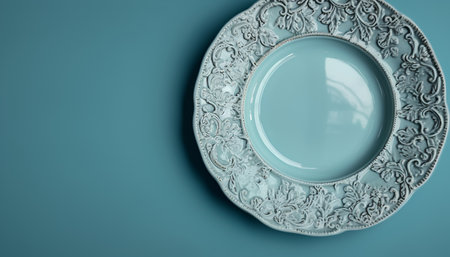 Vintage porcelain plate on blue background, 3d renderの素材