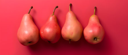 Three ripe red pears on a red background. Top view.の素材