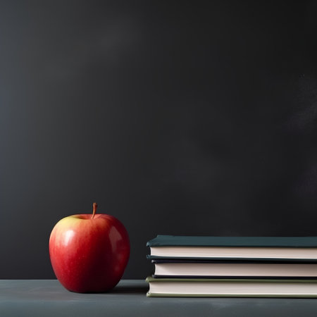 Red apple and books on blackboard background. Back to school conceptの素材