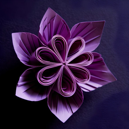 Origami flower made of paper on dark background. Top view.の素材