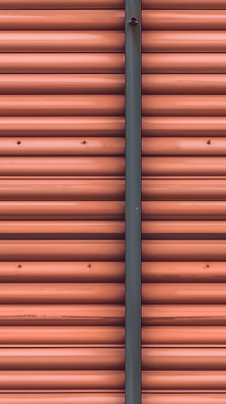 Red corrugated metal sheet texture or background for design with copy space for text or image.の素材