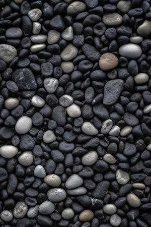 Pebbles on the beach. Black pebbles background.の素材