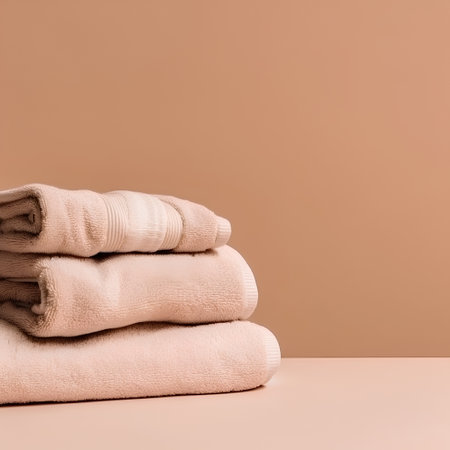 Stack of clean towels on beige background with copy space for textの素材