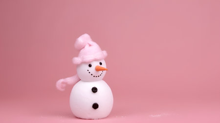 Snowman with pink hat on pink background. Christmas and New Year concept.の素材