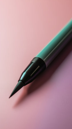 Close up of a green pen on a pink background with copy spaceの素材