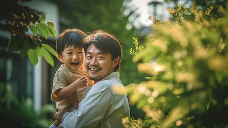 Asian father and son having fun in the garden. Father's day concept.の素材