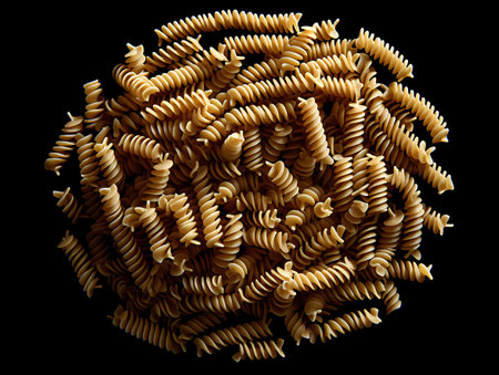 Fusilli pasta spiral isolated on black background. Top view.の素材