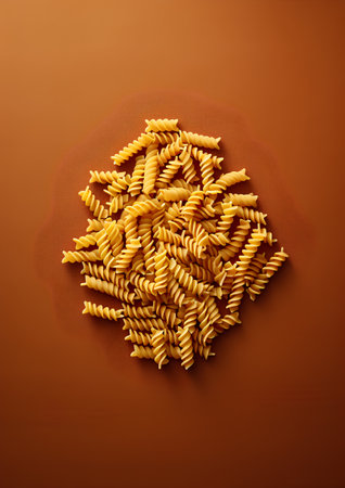 Fusilli pasta on a brown background. Top view. Flat lay.の素材