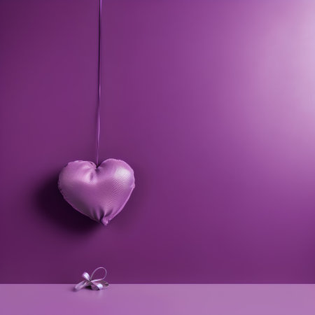 Heart shaped pillow hanging on a string on a purple background. Valentine's day concept.の素材