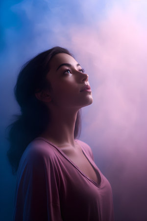Portrait of beautiful young woman in blue smoke. Beauty, fashion.の素材