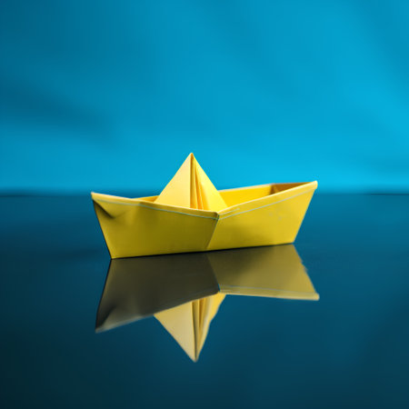 Yellow paper boat on a blue background. The concept of leadership and success.の素材