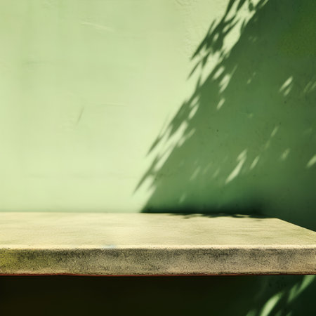Empty top of natural stone table on green wall background. For product displayの素材
