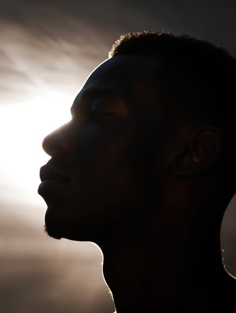 Portrait of a young man on a background of the setting sunの素材