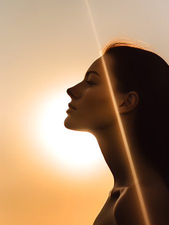 Silhouette of a beautiful woman with closed eyes on the background of the sunの素材