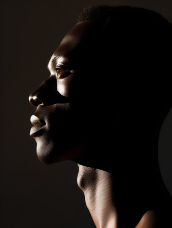 Portrait of a handsome young African man in profile. Studio shot.の素材