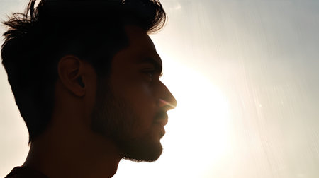 Silhouette of a man with a beard on a sunny dayの素材