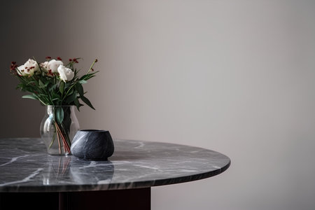 Bouquet of flowers in a vase on a black marble tableの素材