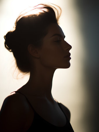 Silhouette of a beautiful young woman with long hair. Beauty, fashion.の素材